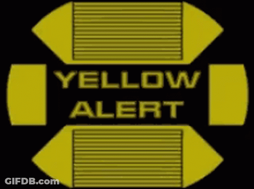 A Yellow And Black Sign That Says Yellow Alert On It GIF