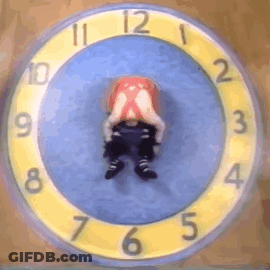 A Yellow And Blue Clock With A Person 'S Head In The Middle GIF