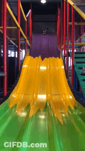 A Yellow And Green Slide With A Purple Top GIF
