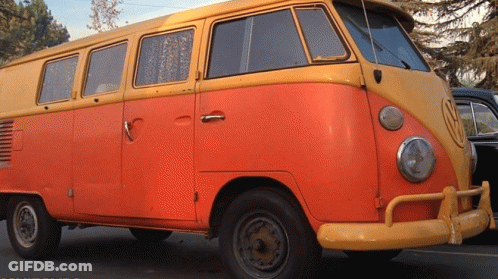 A Yellow And Orange Van With A Vw Logo On The Front GIF