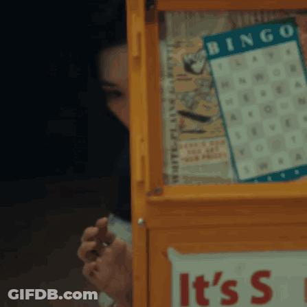A Yellow Box With A Bingo Board On It GIF
