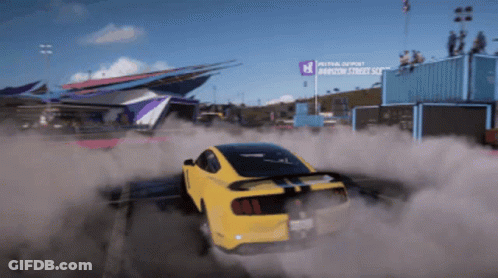 A Yellow Car Is Drifting In Front Of A Sign That Says Festival Depost GIF
