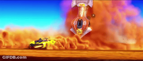 A Yellow Car Is Driving Down A Dirt Road In Front Of A Huge Explosion GIF