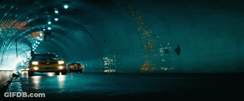 A Yellow Car Is Driving Through A Tunnel GIF