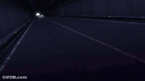 A Yellow Car With A License Plate That Says ' A ' On It Is Driving Through A Dark Tunnel GIF