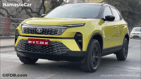 A Yellow Car With A License Plate That Says Mh14tc206ak GIF
