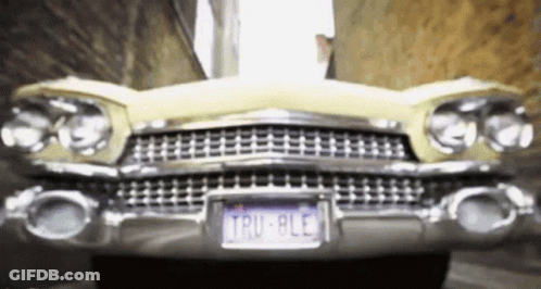 A Yellow Car With A License Plate That Says Tru 8Le GIF