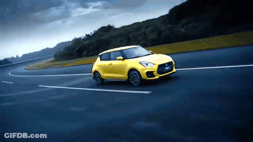 A Yellow Car With The Word Swift On The Side GIF