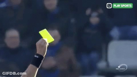 A Yellow Card Is Being Held Up In Front Of A Play Sports Sign GIF