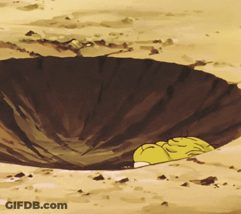 A Yellow Cartoon Character Is Laying In A Hole In The Ground GIF