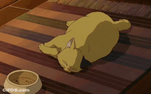 A Yellow Cat Is Laying On A Striped Rug Next To A Bowl Of Food GIF