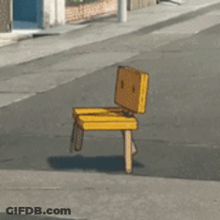 A Yellow Chair Is Sitting On The Sidewalk On The Side Of The Road GIF