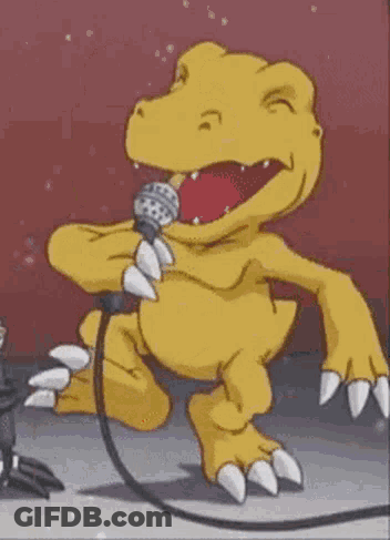 A Yellow Dinosaur Is Singing Into A Microphone While Standing On A Stage . GIF
