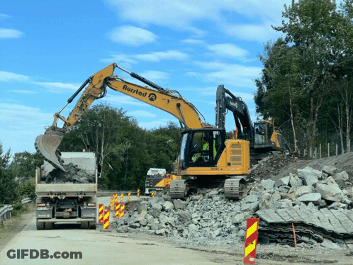 A Yellow Excavator With The Word Rustad On The Side GIF