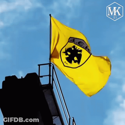 A Yellow Flag With A Black Eagle And The Letter Ak On It GIF
