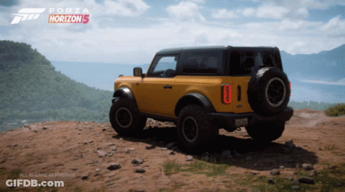 A Yellow Ford Bronco Sits On Top Of A Dirt Hill In A Forza Horizon 5 Video Game GIF