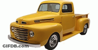 A Yellow Ford Truck Is Sitting On A White Surface GIF