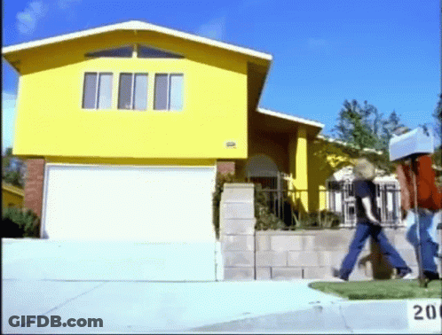 A Yellow House With A Box On Top Of It GIF