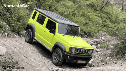 A Yellow Jeep Is Driving Down A Rocky Road With Namaste Car Written On The Bottom GIF