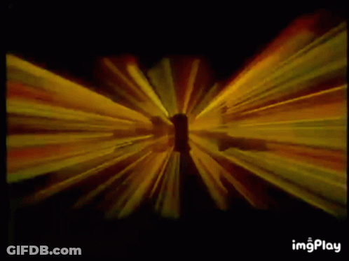 A Yellow Light Beam Is Coming Out Of A Hole In A Black Background GIF