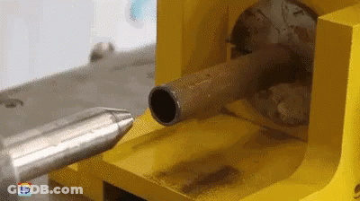 A Yellow Machine Is Cutting A Metal Pipe With A Needle GIF