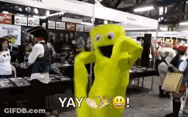 A Yellow Mascot Is Dancing In A Room With People In Costume . GIF