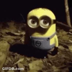 A Yellow Minion Is Standing In A Pile Of Leaves . GIF