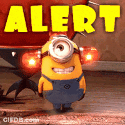 A Yellow Minion Is Standing In Front Of A Sign That Says " Alert " GIF
