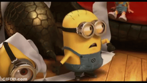 A Yellow Minion Wearing Goggles Is Standing On A Wooden Floor GIF