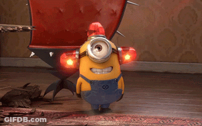 A Yellow Minion Wearing Overalls Has A Red Light On His Head GIF