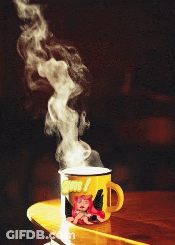 A Yellow Mug With A Picture Of A Girl And The Word Gm On It GIF