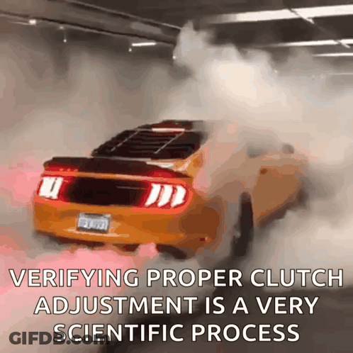 A Yellow Mustang Is Driving Through A Parking Garage With Smoke Coming Out Of The Exhaust Pipes GIF