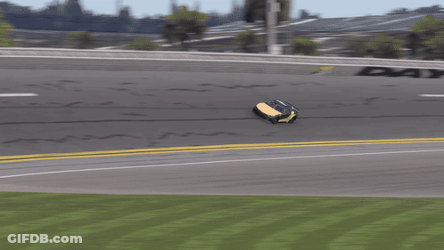 A Yellow Race Car Is Driving Down A Race Track GIF