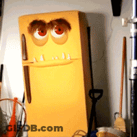 A Yellow Refrigerator With A Cartoon Face Painted On It GIF