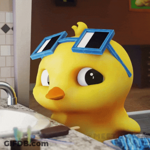 A Yellow Rubber Duck Wearing Blue Square Sunglasses Sits On A Bathroom Counter GIF