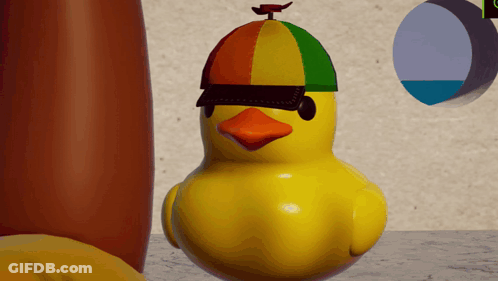 A Yellow Rubber Duck With A Colorful Hat On GIF