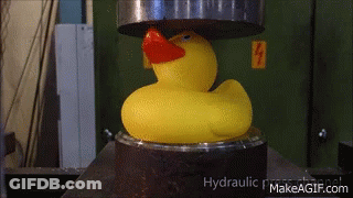 A Yellow Rubber Duck With A Red Beak Is Being Pressed Under A Hydraulic Press GIF