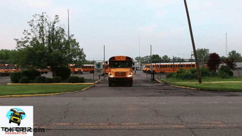 A Yellow School Bus Is Parked In A Parking Lot With The Foundation Logo In The Corner GIF