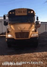 A Yellow School Bus Is Parked In Front Of A Building With The Caption " Its All Aubrey 'S Fault " GIF