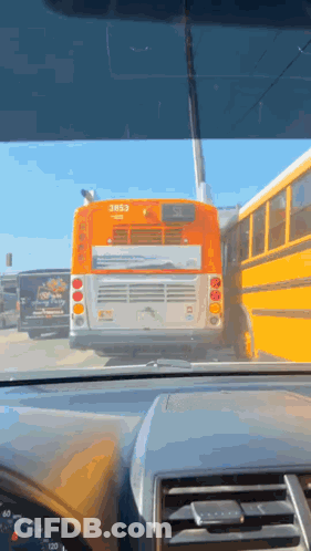 A Yellow School Bus With The Number 3853 On The Back GIF