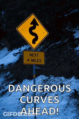 A Yellow Sign That Says Next 4 Miles Is Next To A Sign That Says Dangerous Curves Ahead GIF