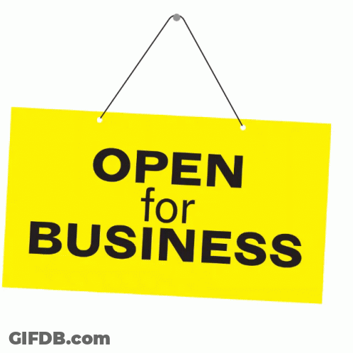 A Yellow Sign That Says Open For Business Hangs On A String GIF