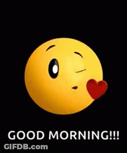 A Yellow Smiley Face Is Blowing A Kiss With A Red Heart On Its Nose . GIF