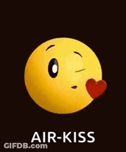 A Yellow Smiley Face Is Blowing A Kiss With A Red Heart . GIF