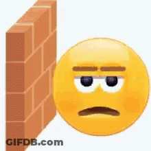 A Yellow Smiley Face With A Sad Face Is Leaning Against A Brick Wall . GIF