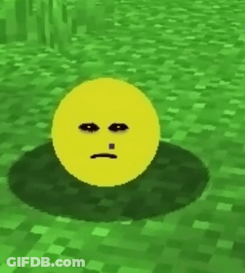 A Yellow Smiley Face With A Tooth Is Sitting In The Grass . GIF
