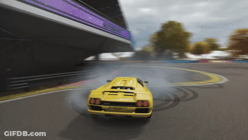 A Yellow Sports Car Is Drifting On A Track With Smoke Coming Out Of The Tires GIF