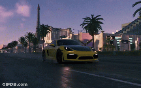 A Yellow Sports Car Is Driving Down A Wet Road GIF