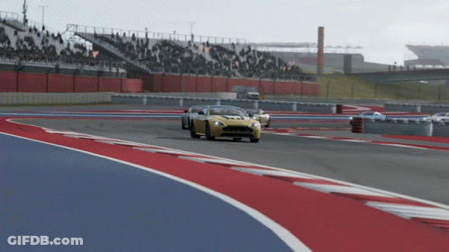 A Yellow Sports Car Is On A Race Track GIF