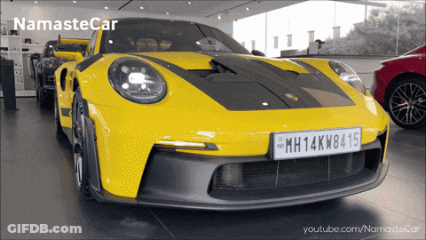 A Yellow Sports Car With A License Plate That Says Mh14kw8415 GIF